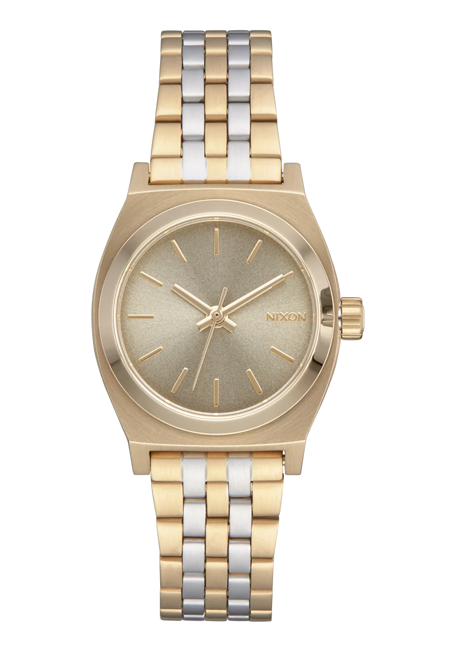 A Nixon analog watch with a two-tone gold and silver metal bracelet, a gold-tone case, and a textured champagne-gold dial.