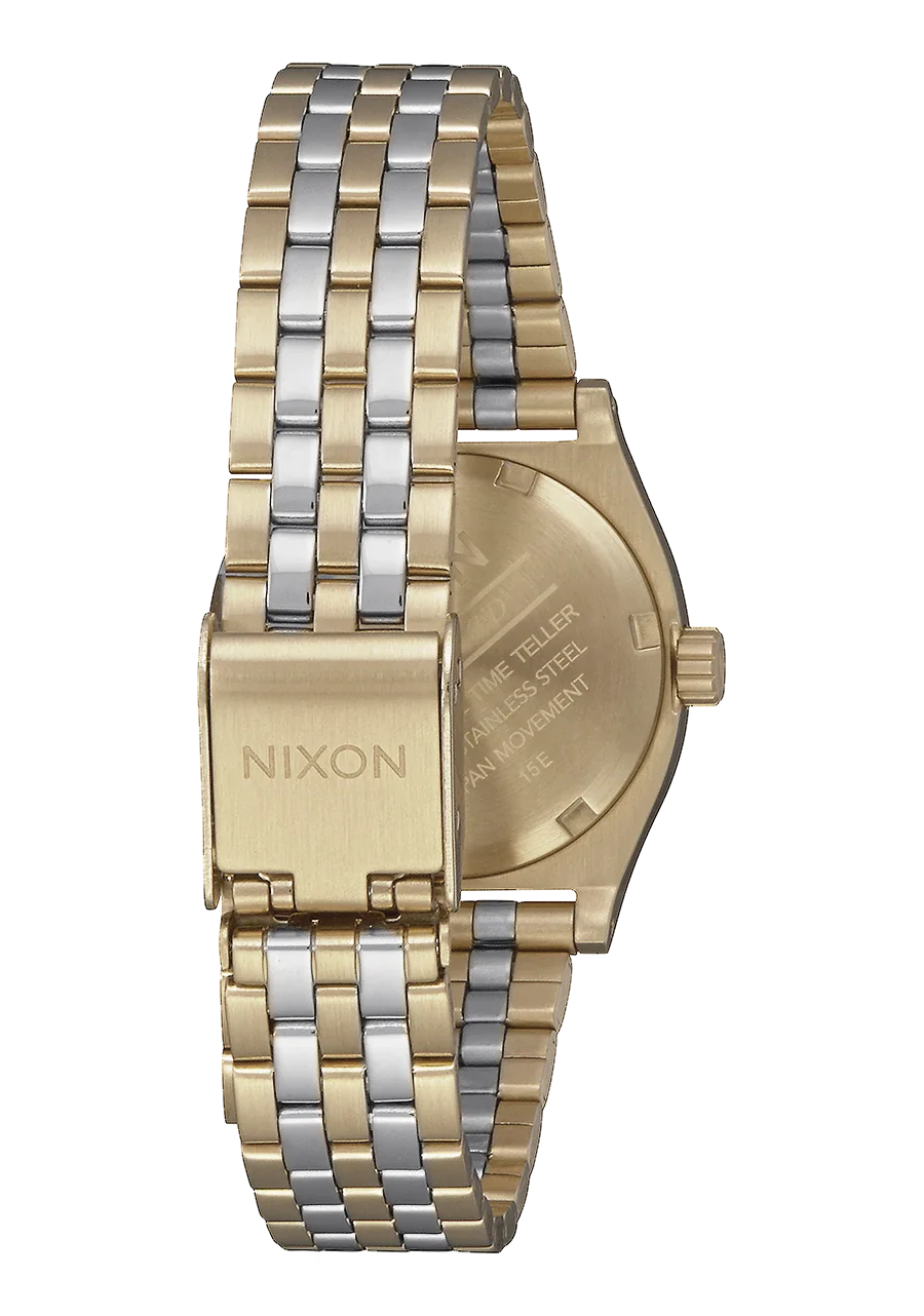 Nixon wristwatch shown from the back, featuring a two-tone stainless steel and gold-tone metal bracelet with a brushed gold-tone case.