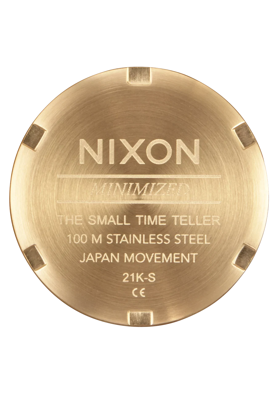 Gold Nixon watch case on a white background